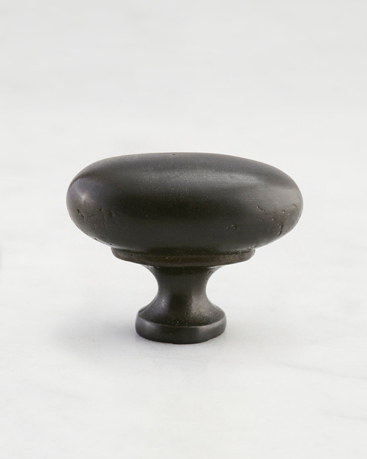 A 'Large' oval-shaped knob for a kitchen cupboard or drawer with a matt black bronze finish that makes it look like a beloved, well aged brass from centuries ago. TEST