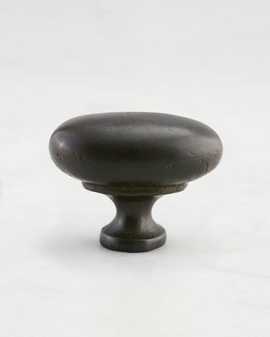 A 'Large' oval-shaped knob for a kitchen cupboard or drawer with a matt black bronze finish that makes it look like a beloved, well aged brass from centuries ago.