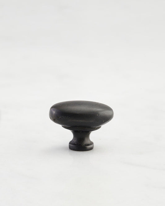 A 'Petite' oval-shaped knob for a kitchen cupboard or drawer with a matt black bronze finish.