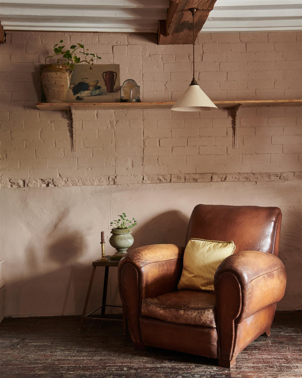 A vintage leather armchair in front of a pink brick wall and long pine shelf with Victorian-inspired ornate pink painted shelf brackets. | Aged Brass Large shown TEST