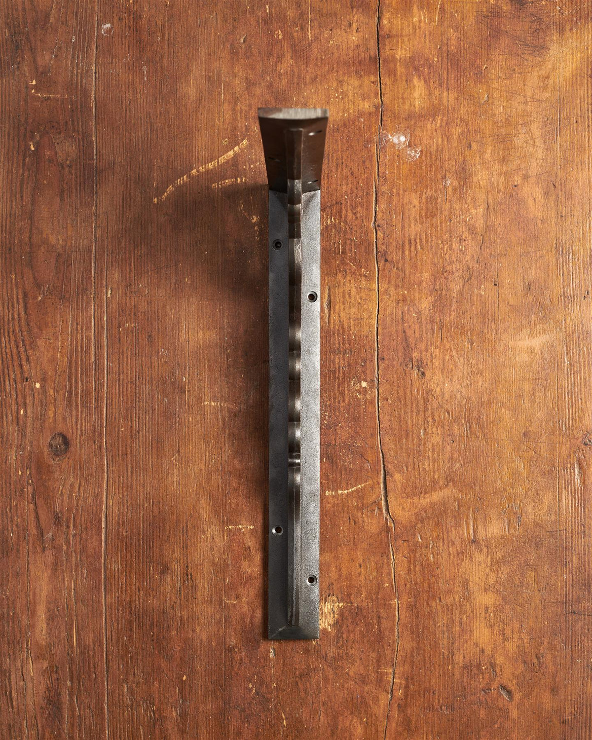 A front profile view of a large Victorian-inspired ornate shelf bracket in a cast iron finish. TEST