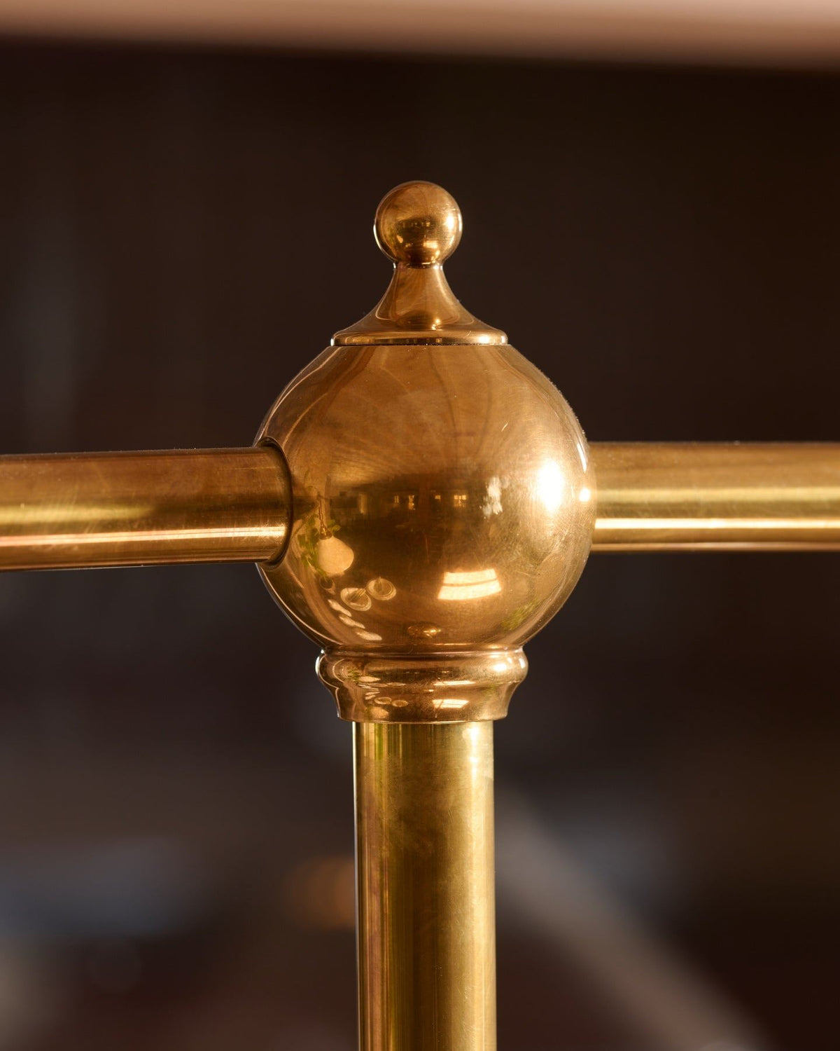 A close-up view of a pointed brass finial. TEST