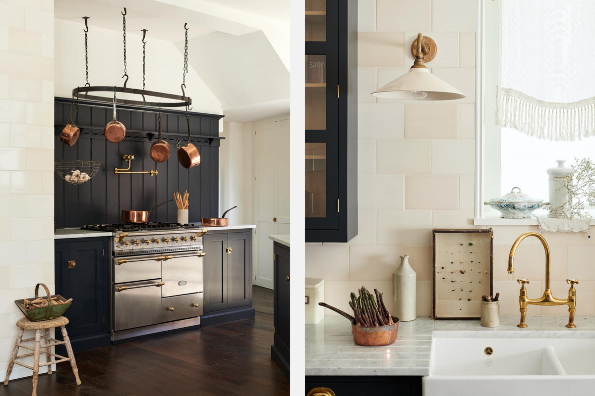A large pantry blue shaker kitchen features a sink and cooker run with Carrara marble worktop, a silver gas cooker, a shelf with pegs, and a double Belfast sink, an aged brass Ionian tap,. Beautifully decorated with vintage furniture, copper pans, a pot hanger, and an aged brass pot filler tap, the kitchen presents a thoughtfully curated mix of collected pieces that fit together effortlessly.