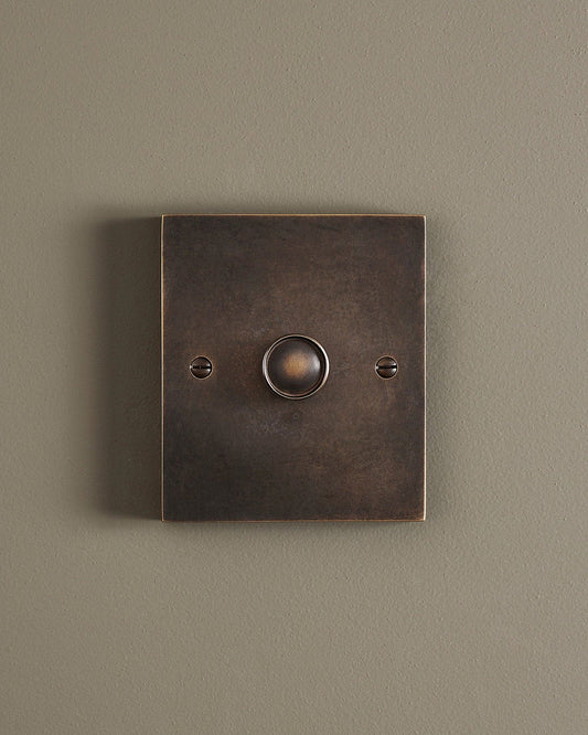 A straight-on view of a 1 gang box dimmer switch in a dark oxidised brass finish.