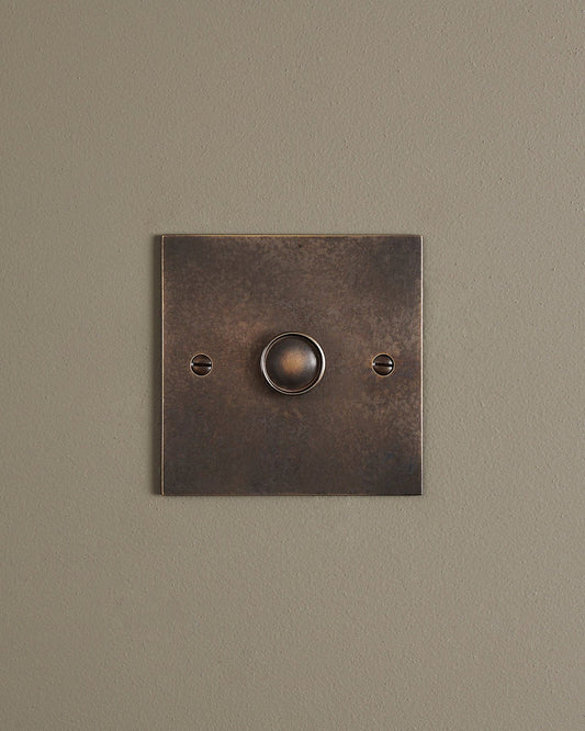A straight-on view of a 1 gang classic dimmer switch in a dark oxidised brass finish.