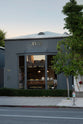 Outside our LA showroom with tall windows that show a peek at the beautiful and functional Trinity blue Heirloom kitchen.