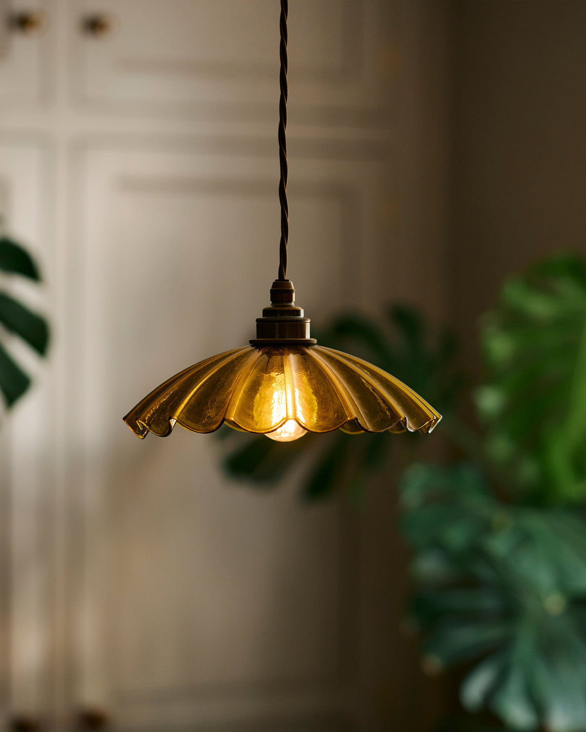 A close up image of the frilly glass chartreuse pendant light.