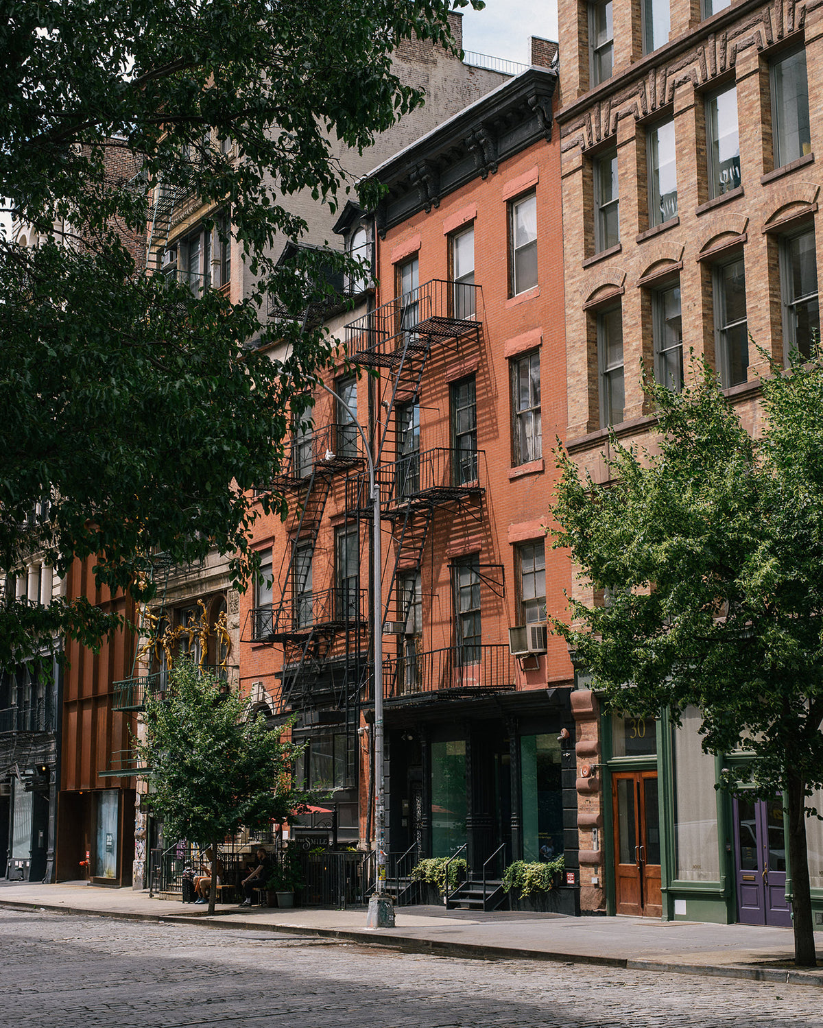 The deVOL Bond Street, New York showroom is a four story high, red bricked building with the classic metal fire escape ladders.