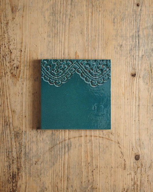 Teal card with lace design on a wooden surface. | Florentine Scallop Square