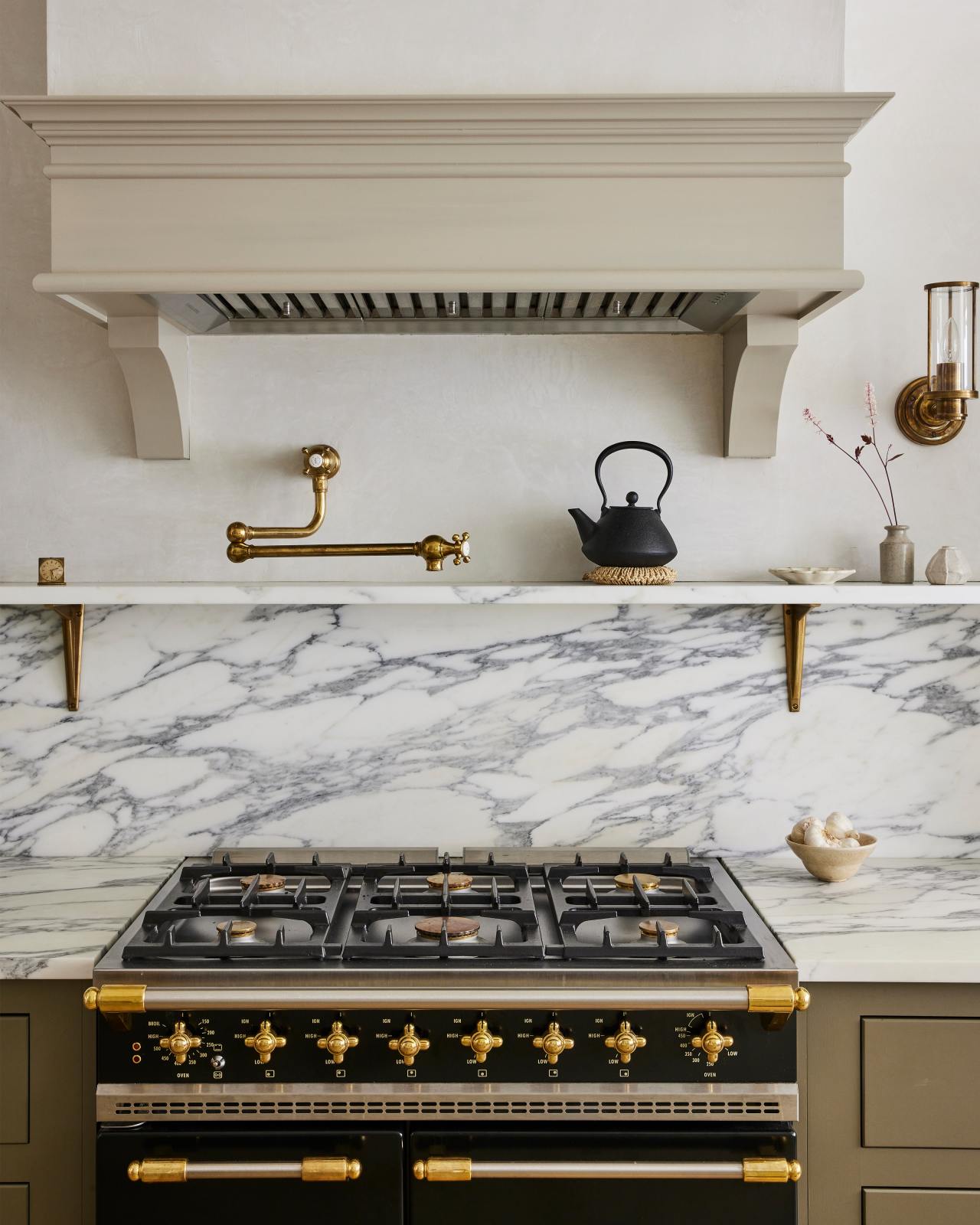 pot rack on tile wall, with ceiling hood vent (Devol kitchens) Devol