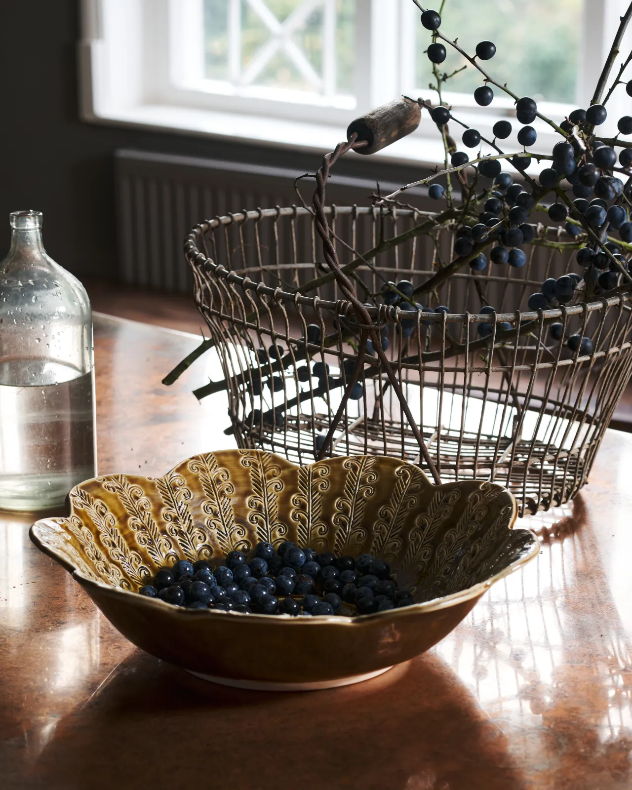Heirloom Petal Bowl in Dark Gold Colour with blueberries on a copper worktop.
