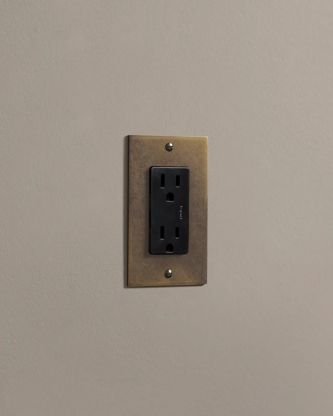 a side on shot of the standard outlet on an oxidised brass plate.