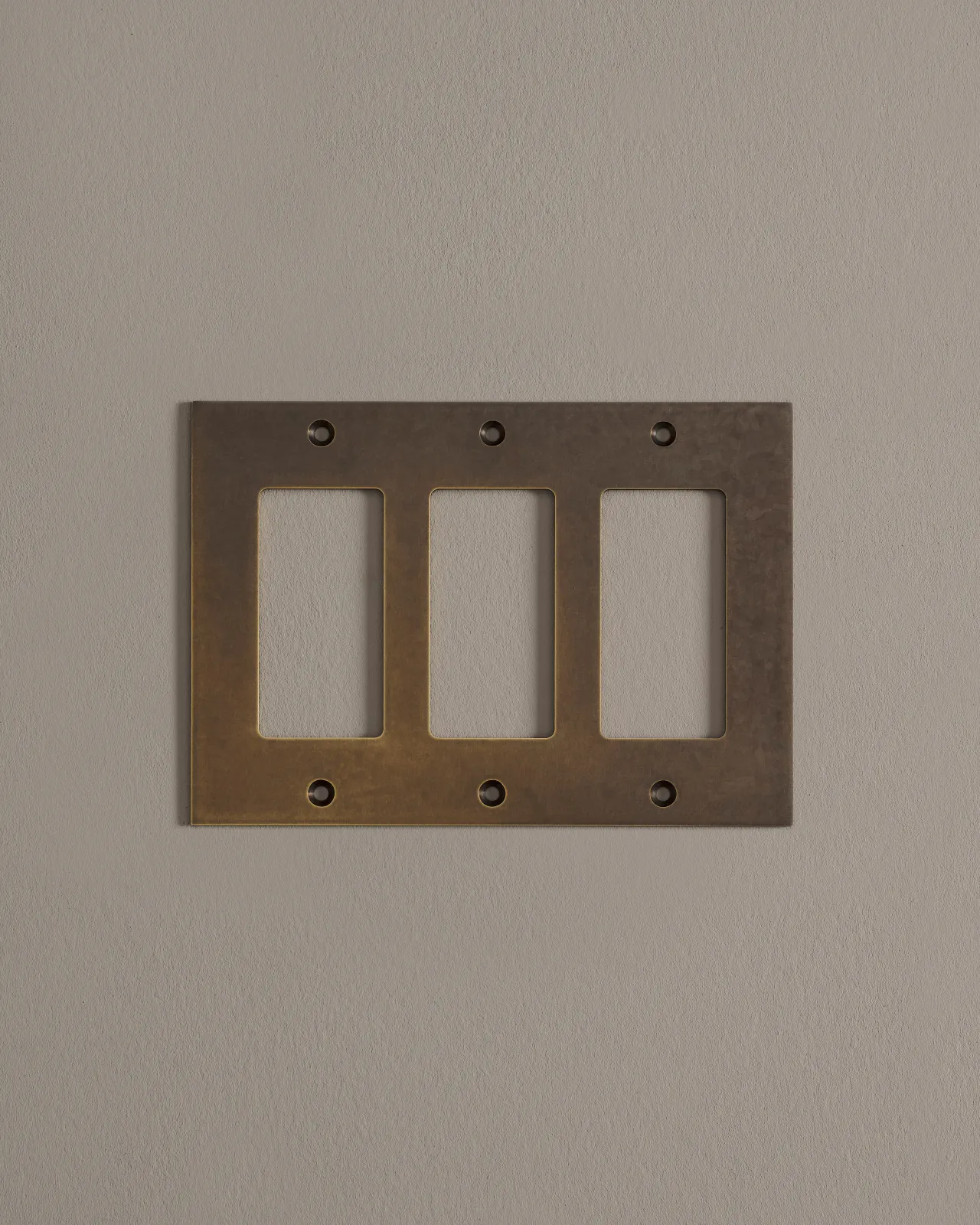 a front on shot of the decora cover plate in oxidised brass finish.
