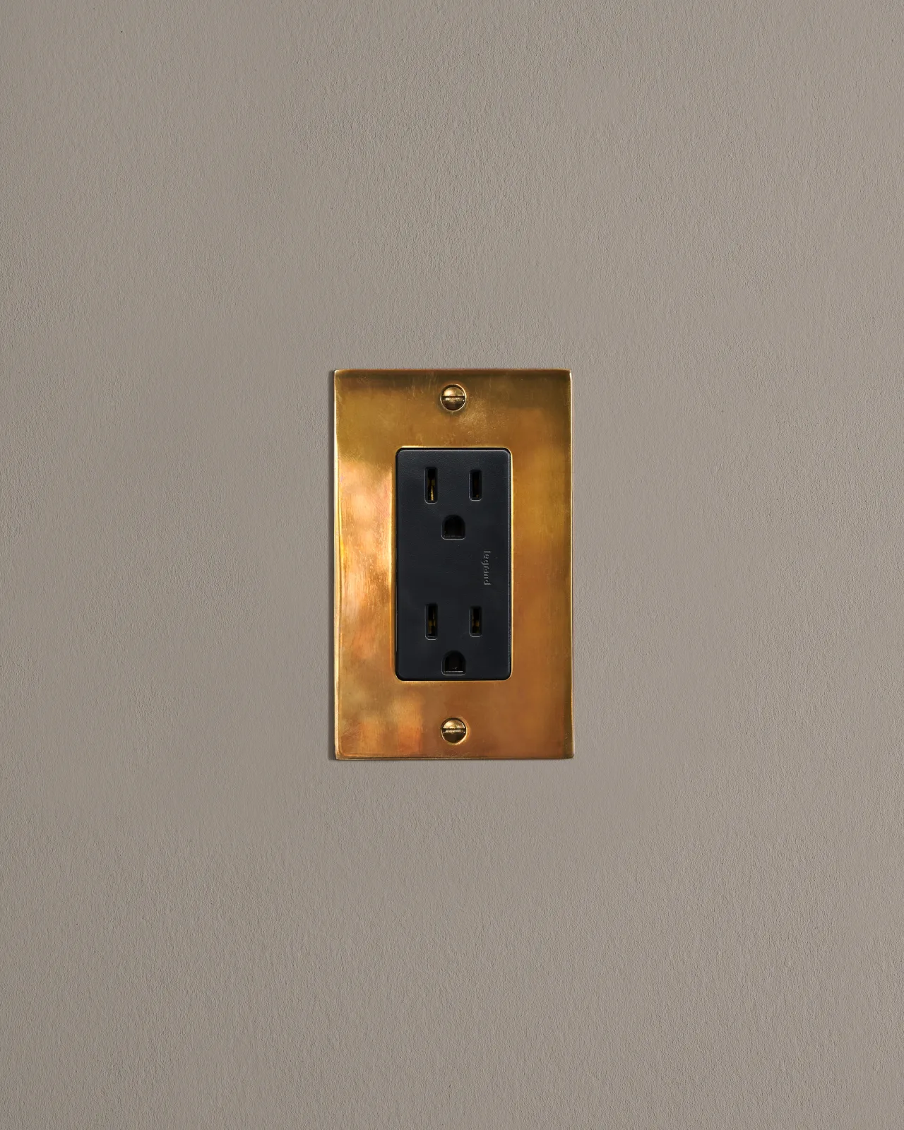 a front on shot of the standard outlet on an heirloom brass plate.