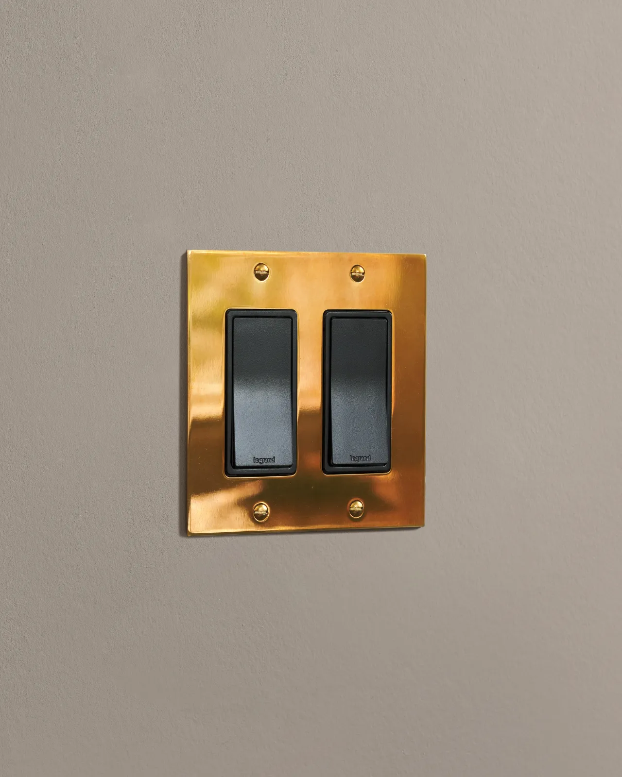 a side on shot of the rocker switch on an heirloom brass plate.