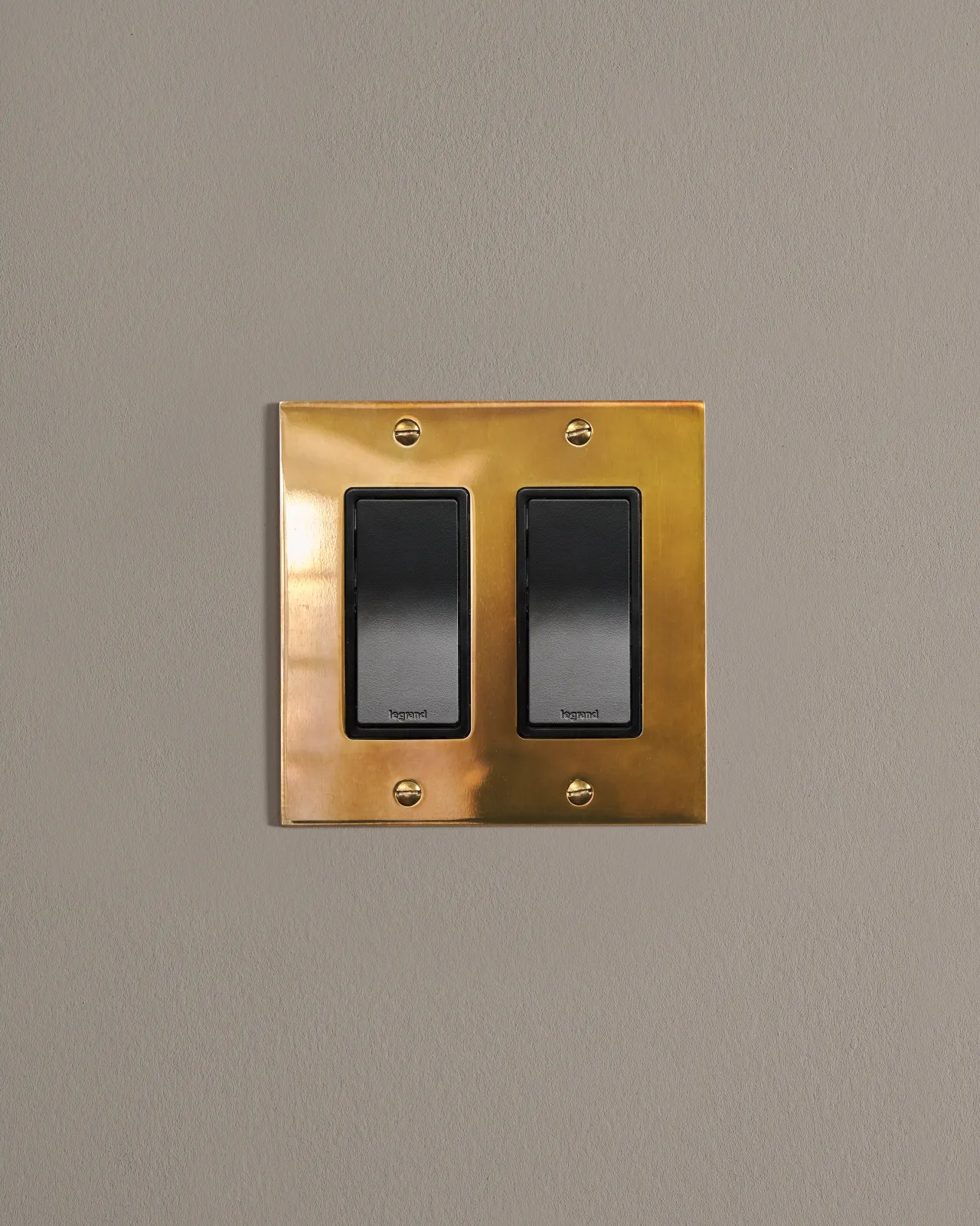 a front on shot of the rocker switch on an heirloom brass plate.