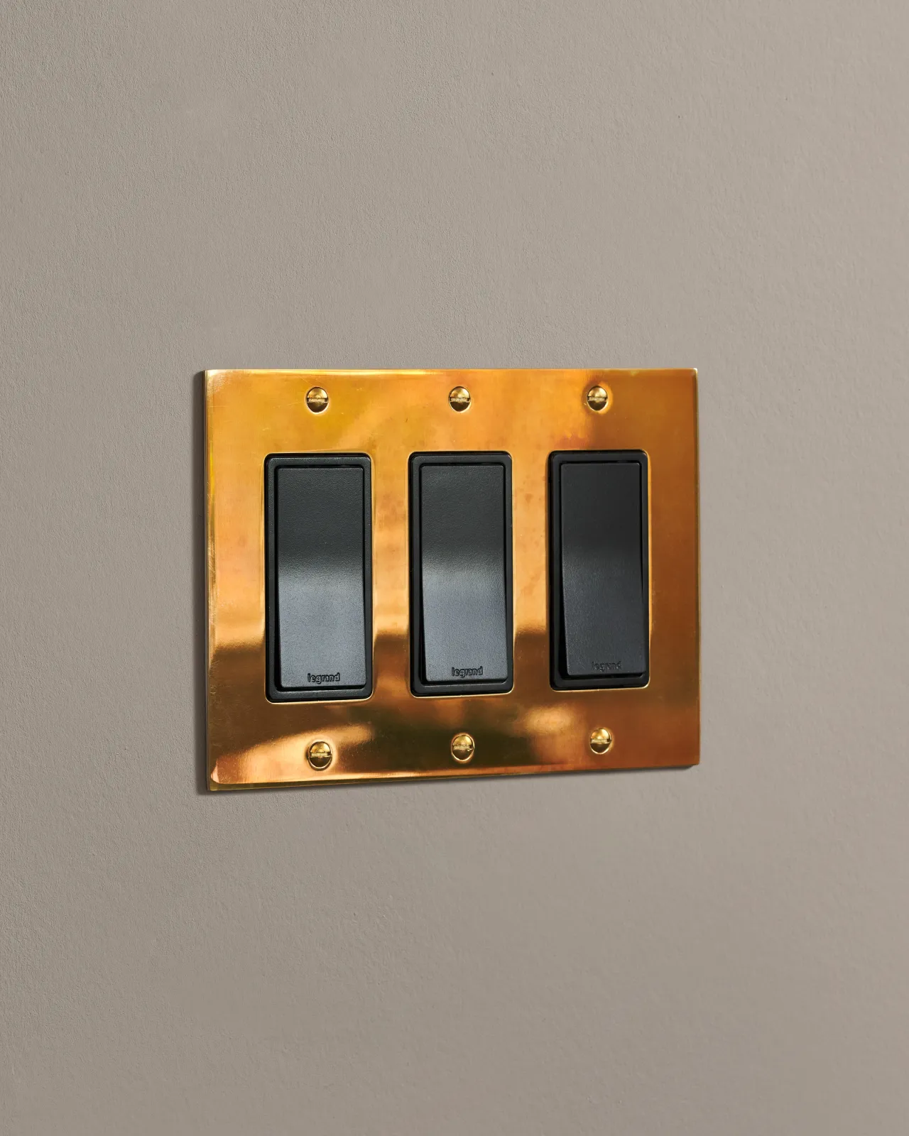 a side on shot of the rocker switch on an heirloom brass plate.