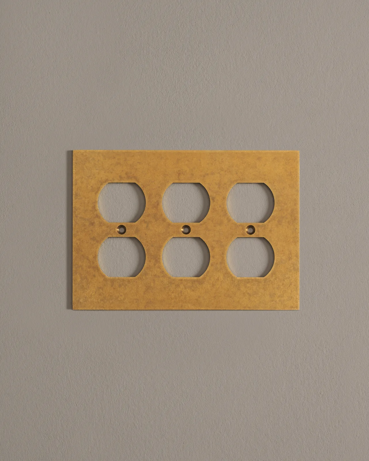 a front on shot of the duplex outlet cover plate in aged brass.