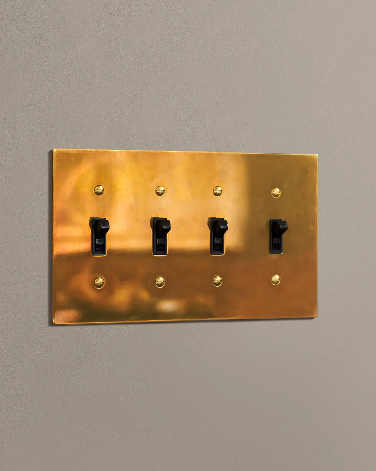 a side on shot of the toggle switch on an heirloom brass cover plate.