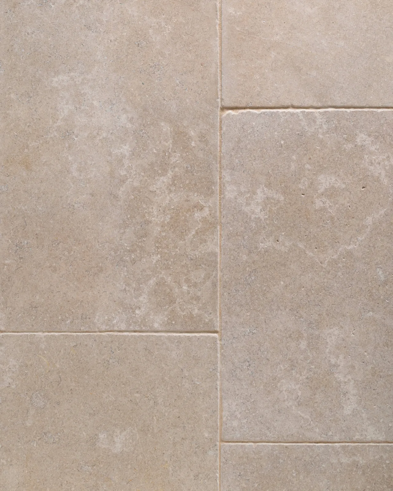 a top down image of the dijon tumbled limestone, looking soft and warm cream, showing the flooring layout.
