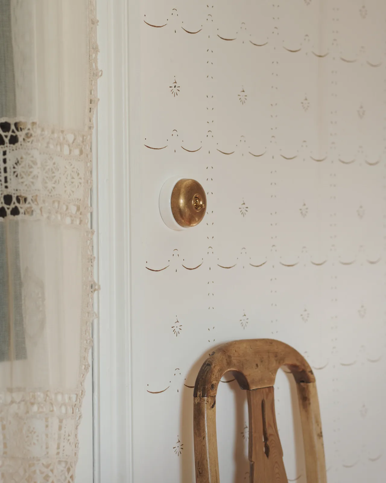 A deVOL Aged Brass Dolly Toggle Switch with a white base fitted to a light and airy room.