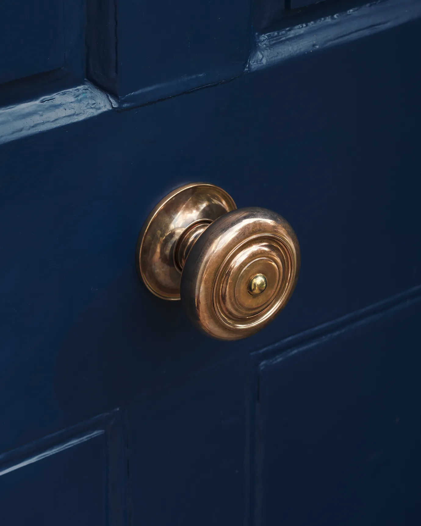 the grand romilly centrepull on a blue wooden door.