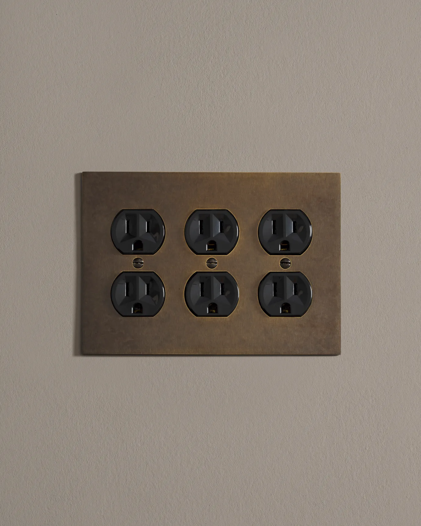 a front on shot of the duplex outlet on oxidised brass cover plate.