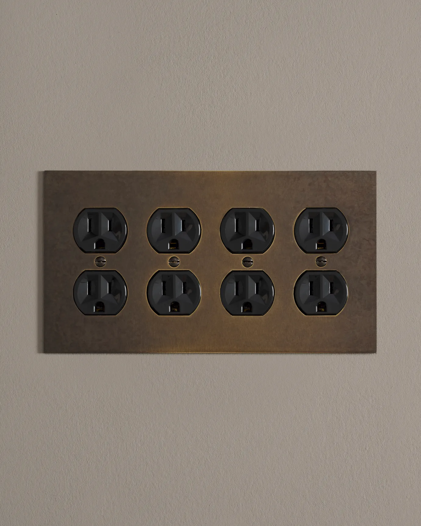 a front on shot of the duplex outlet on oxidised brass cover plate.
