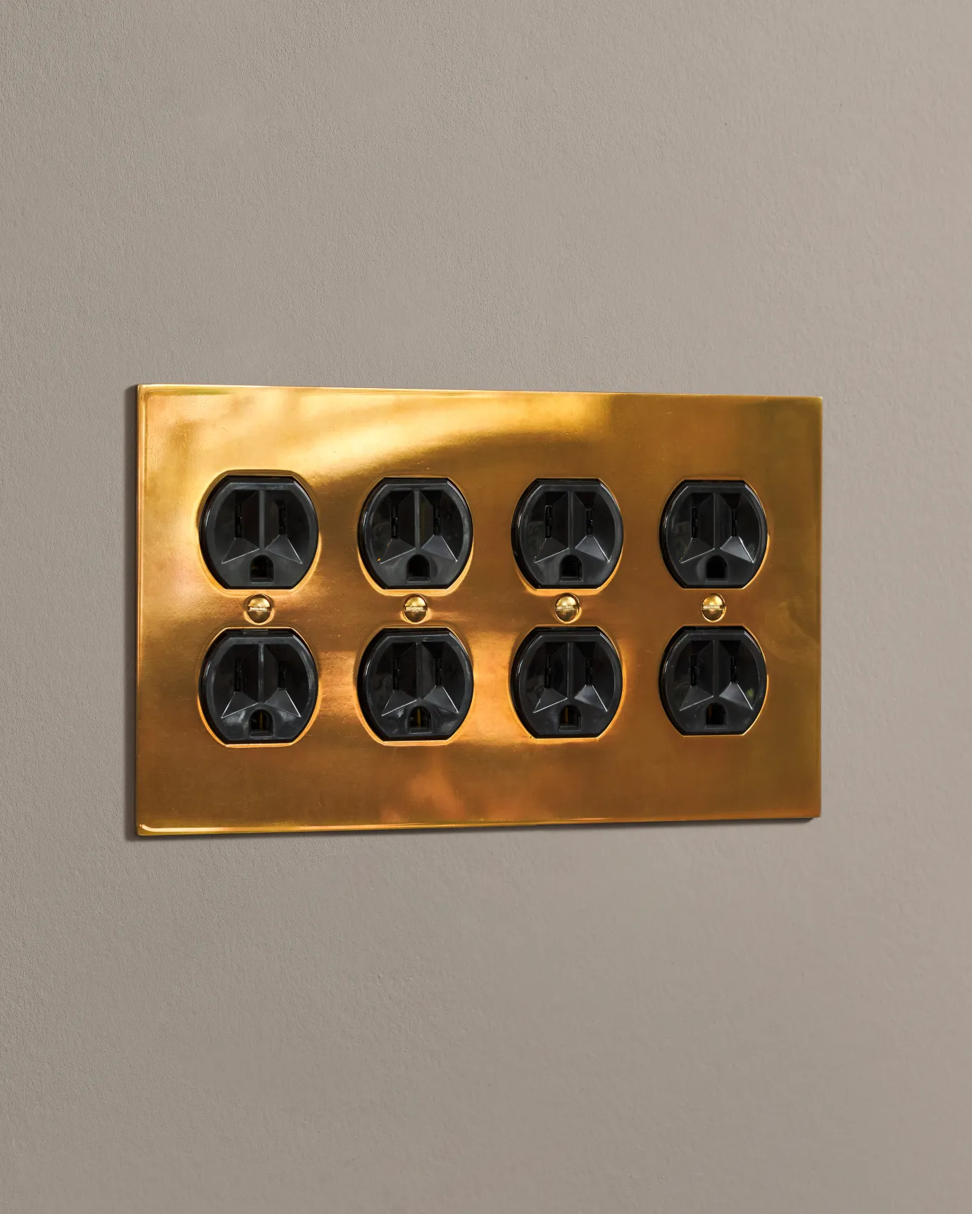 a side on shot of the duplex outlet on an heirloom brass cover plate.