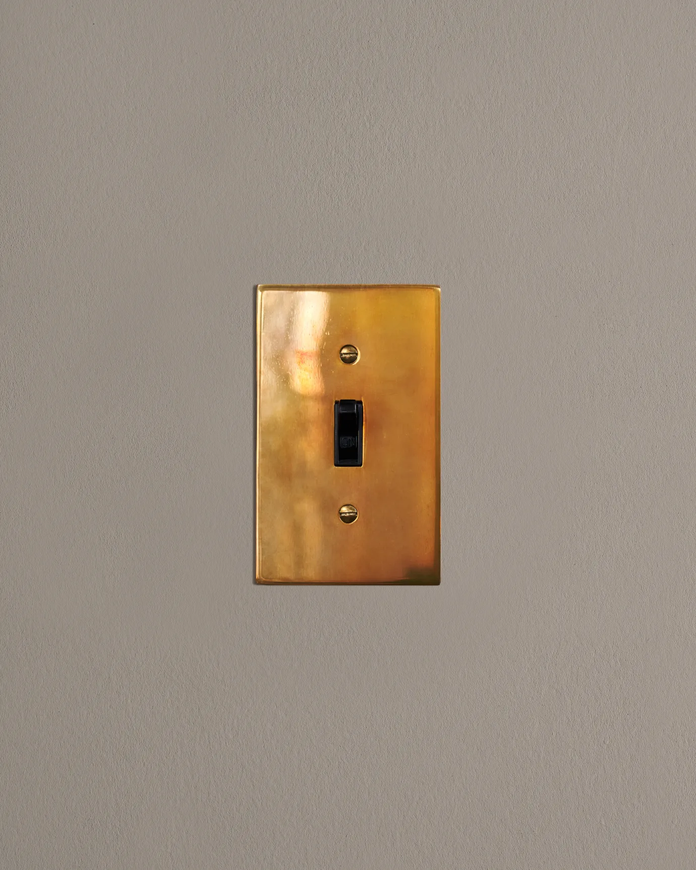 a front on shot of the toggle switch on an heirloom brass cover plate.
