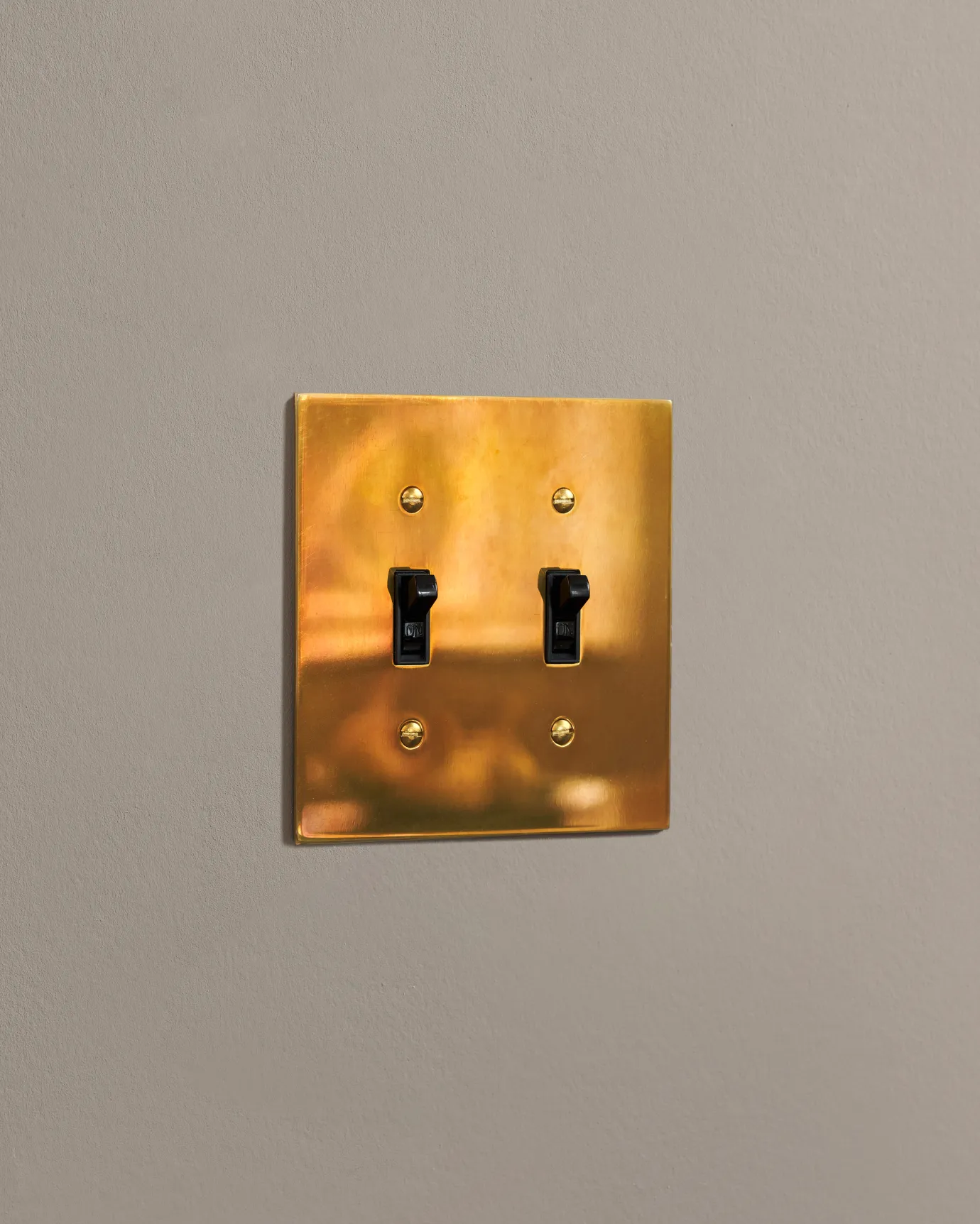 a side on shot of the toggle switch on an heirloom brass cover plate.