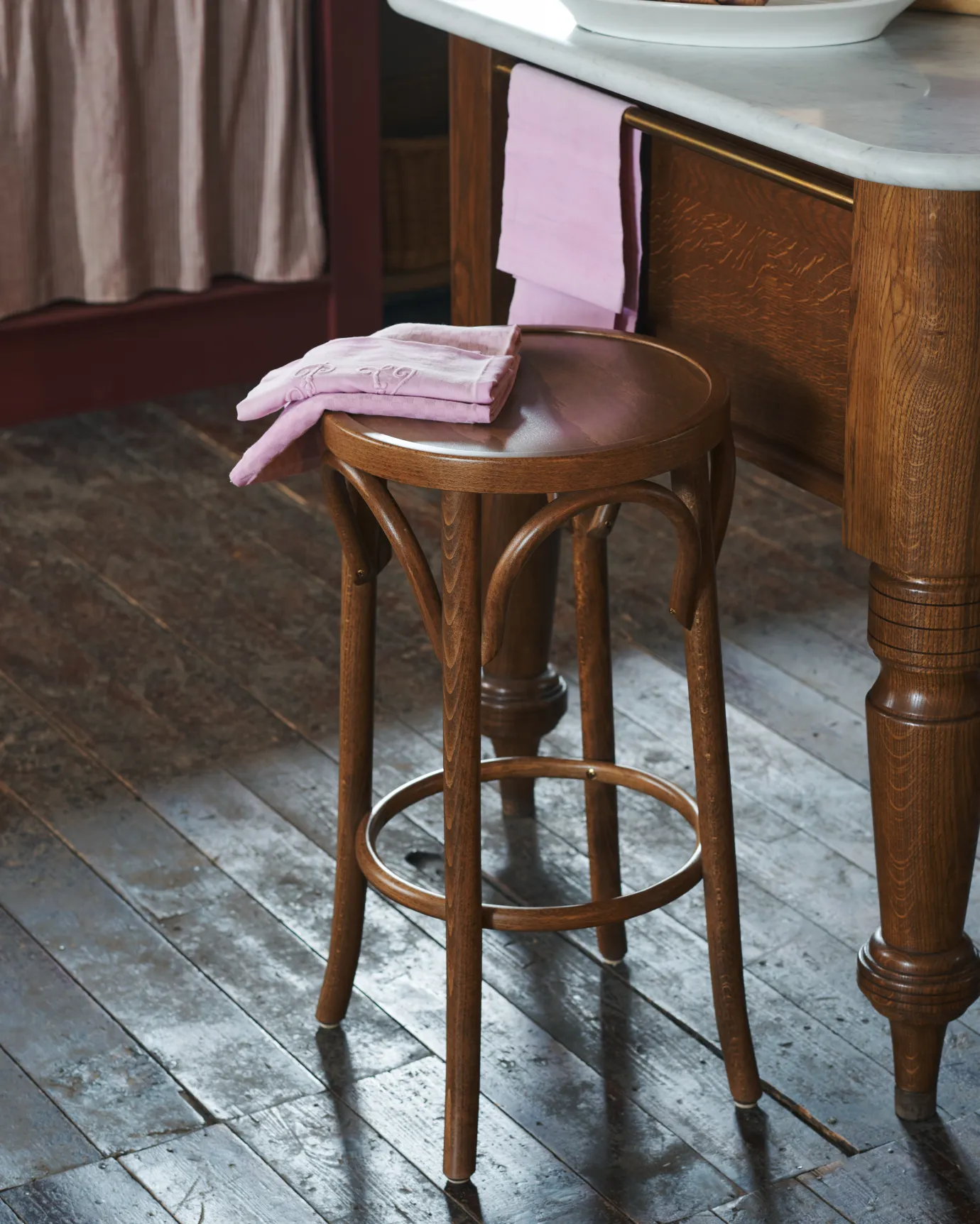 a scene shot on the classic bentwood cafe stool with pink tea towel on it.